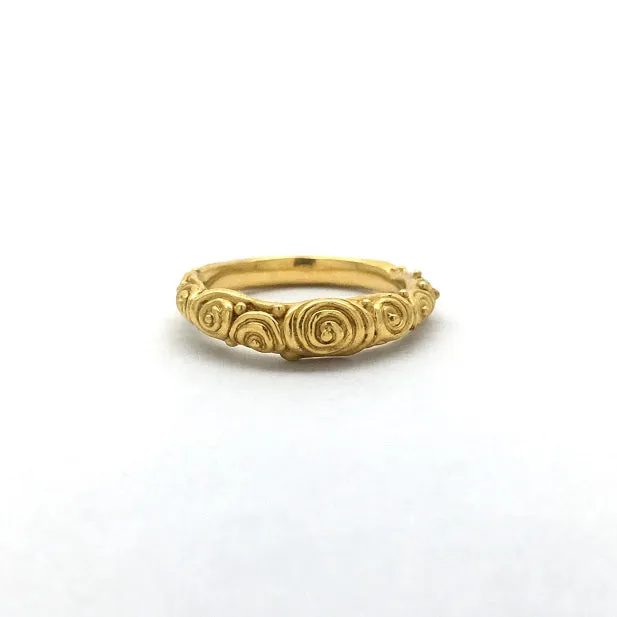 Simple tapered band surfaced with spirals and mock granulation elements inspired by antiquity